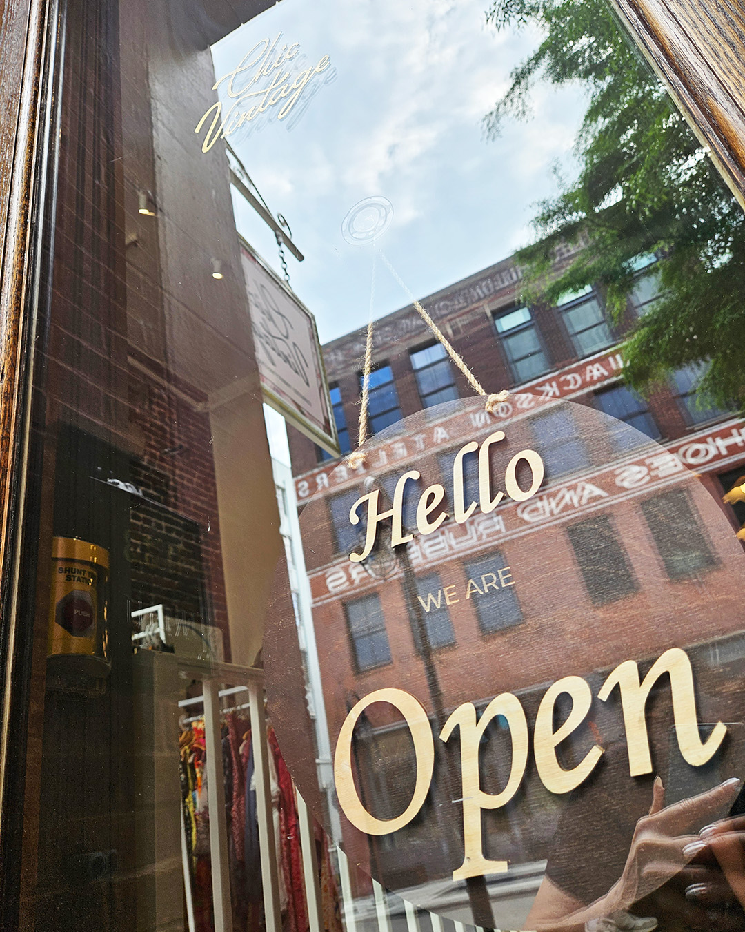 Hand-lettered 'Hello we are Open' sign in the Chic Vintage front door
